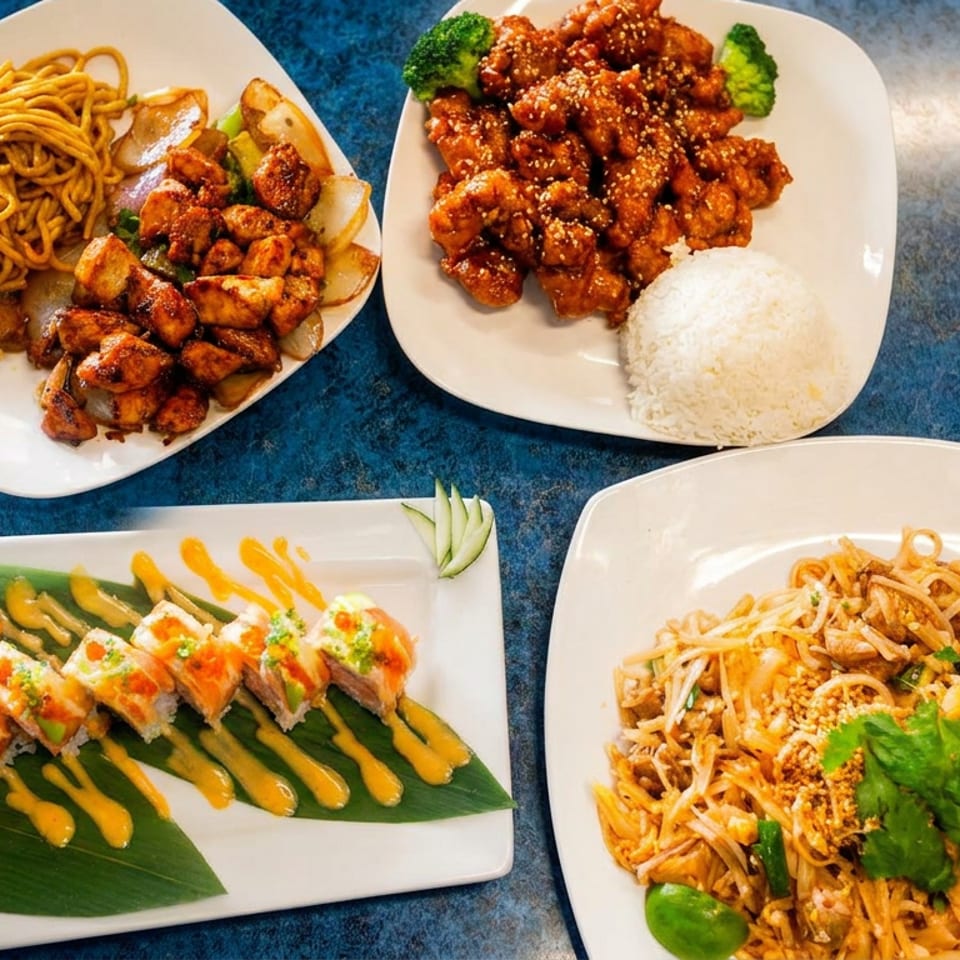 Four plates of Asian cuisine: noodles with chicken, sesame chicken with rice, sushi rolls, and pad Thai.